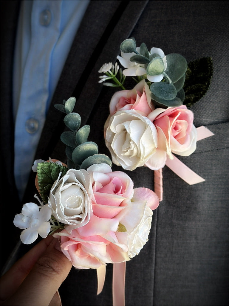 Prom boutonniere and corsage set with pink and ivory roses and greenery