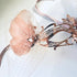 Elegant rose gold masquerade mask with filigree design, flower, netting, and rhinestones for weddings, Venetian balls, and prom parties.