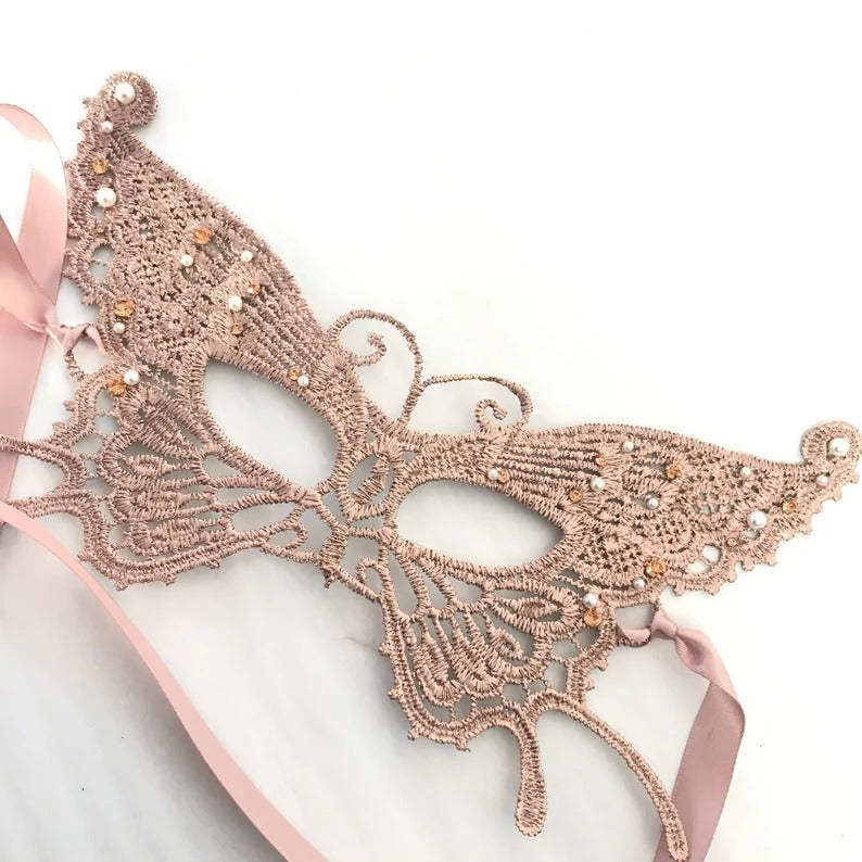 Rose gold lace masquerade mask with pearl and rhinestone accents.