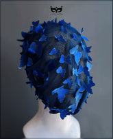 Royal blue butterfly face veil mask featuring dimensional butterfly appliqués attached to a sheer mesh hood, creating a dramatic couture-inspired avant garde fashion accessory for runway shows, cosplay, festivals, theatrical performances, and artistic photoshoots.