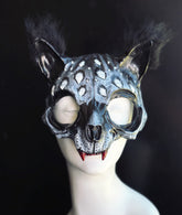 Gray and black Catwoman masquerade mask with faux fur ears, oversized feline eye openings, realistic sculpted details, and red fangs. Perfect for Catwoman facemask searches, masquerade mask cat like costumes, Halloween masks for women, adult masquerade masks for men and women, gothic cosplay, Witcher-inspired costumes, couples costume masquerade looks, black cat woman costumes, midnight masquerade masks, and fantasy animal cosplay.