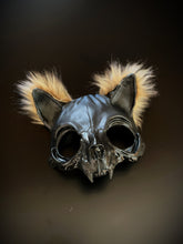 Black cat skull mask with fur tufts, featuring a gothic and eerie design.