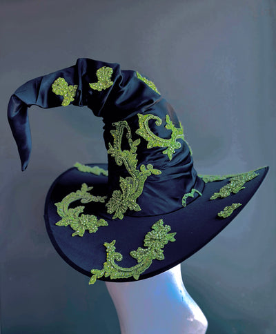 Black witch hat with green embroidered fabric.
