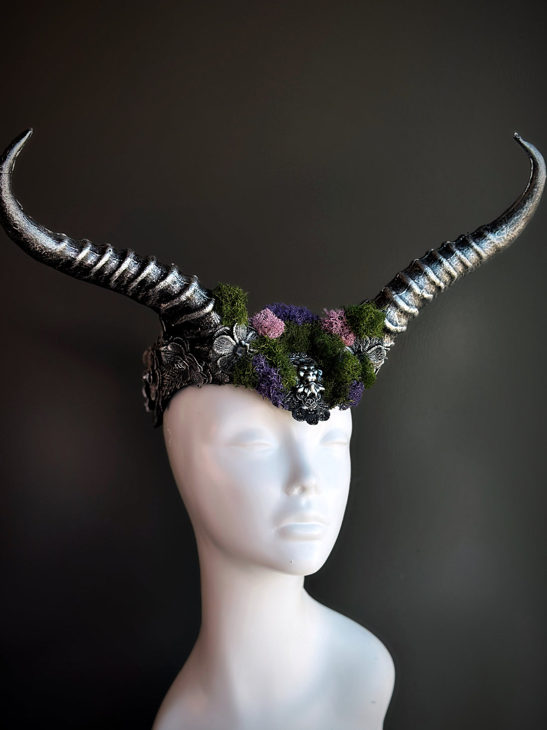 Silver horned headpiece adorned with green and purple moss, perfect for fantasy, gothic, and festival wear.