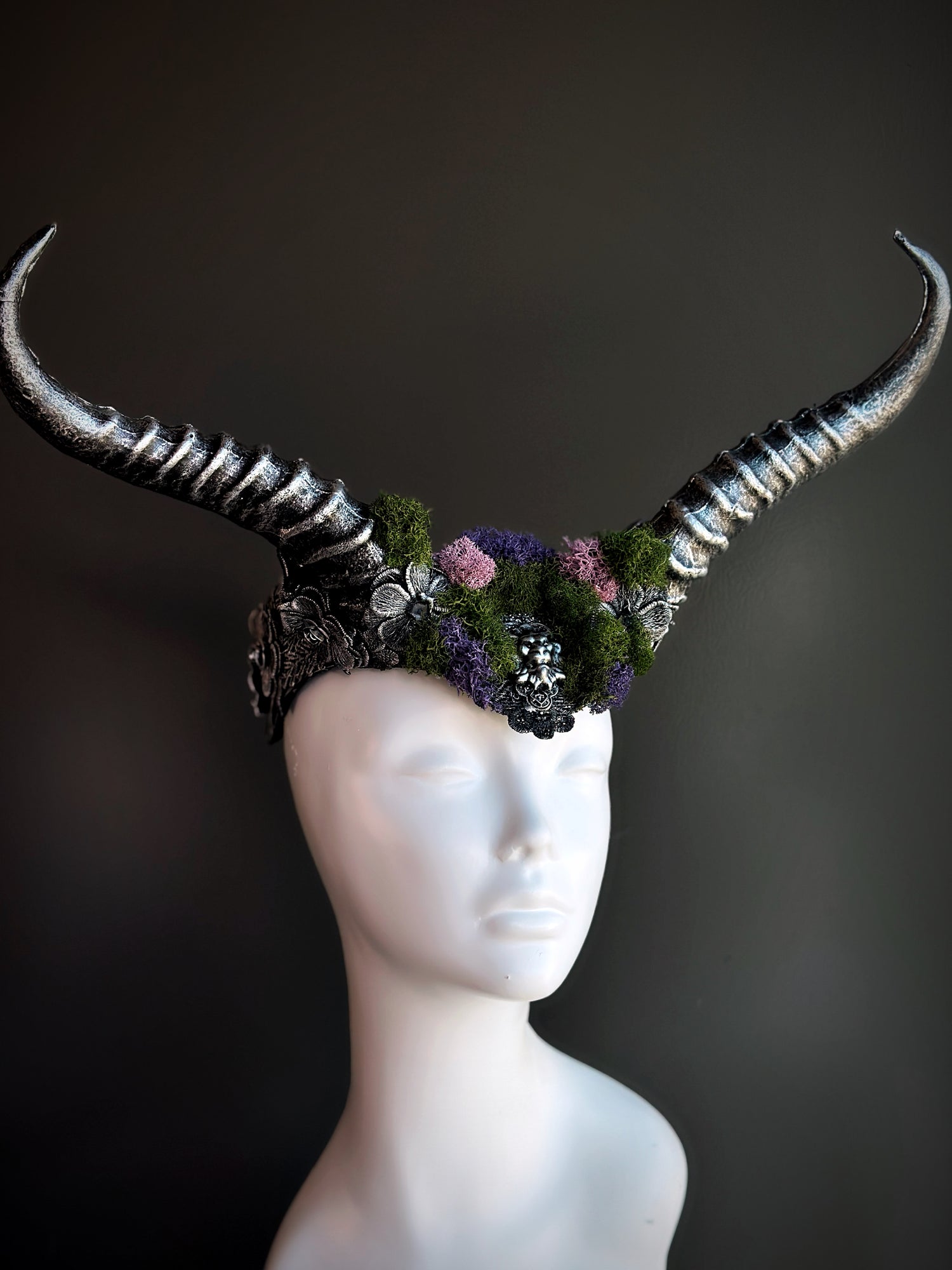 Silver horned headpiece adorned with green and purple moss, perfect for fantasy, gothic, and festival wear.

