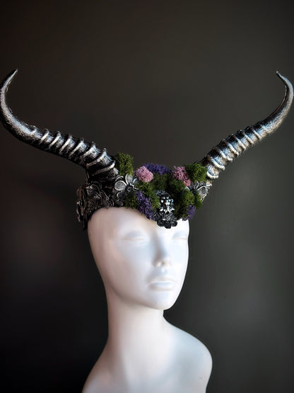 Silver horned headpiece adorned with green and purple moss, perfect for fantasy, gothic, and festival wear.

