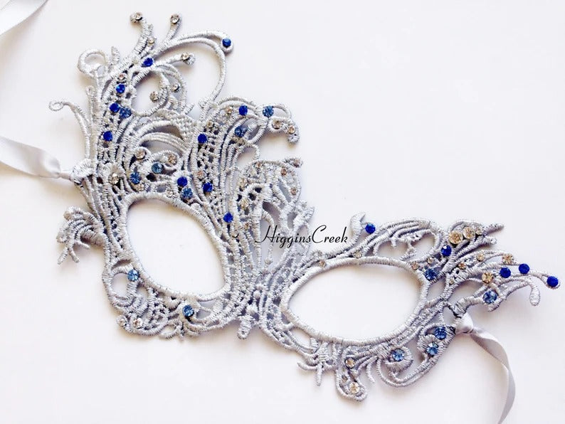 Elegant silver lace masquerade mask with blue rhinestones, ideal for Venetian parties, proms, or weddings.