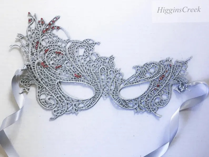 Elegant silver lace masquerade mask with red rhinestones, perfect for proms, formal galas, and Venetian masquerade parties.