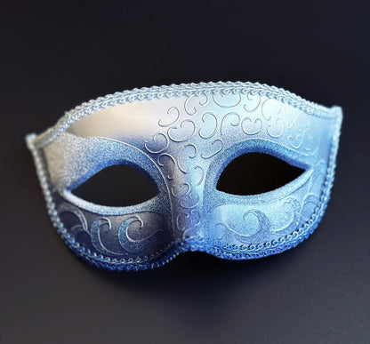 Silver and royal blue Venetian masquerade eye mask with metallic ombre finish, embossed Baroque scrollwork, decorative braided trim, and satin ribbon ties for masquerade balls, Mardi Gras celebrations, gala events, and carnival parties.
