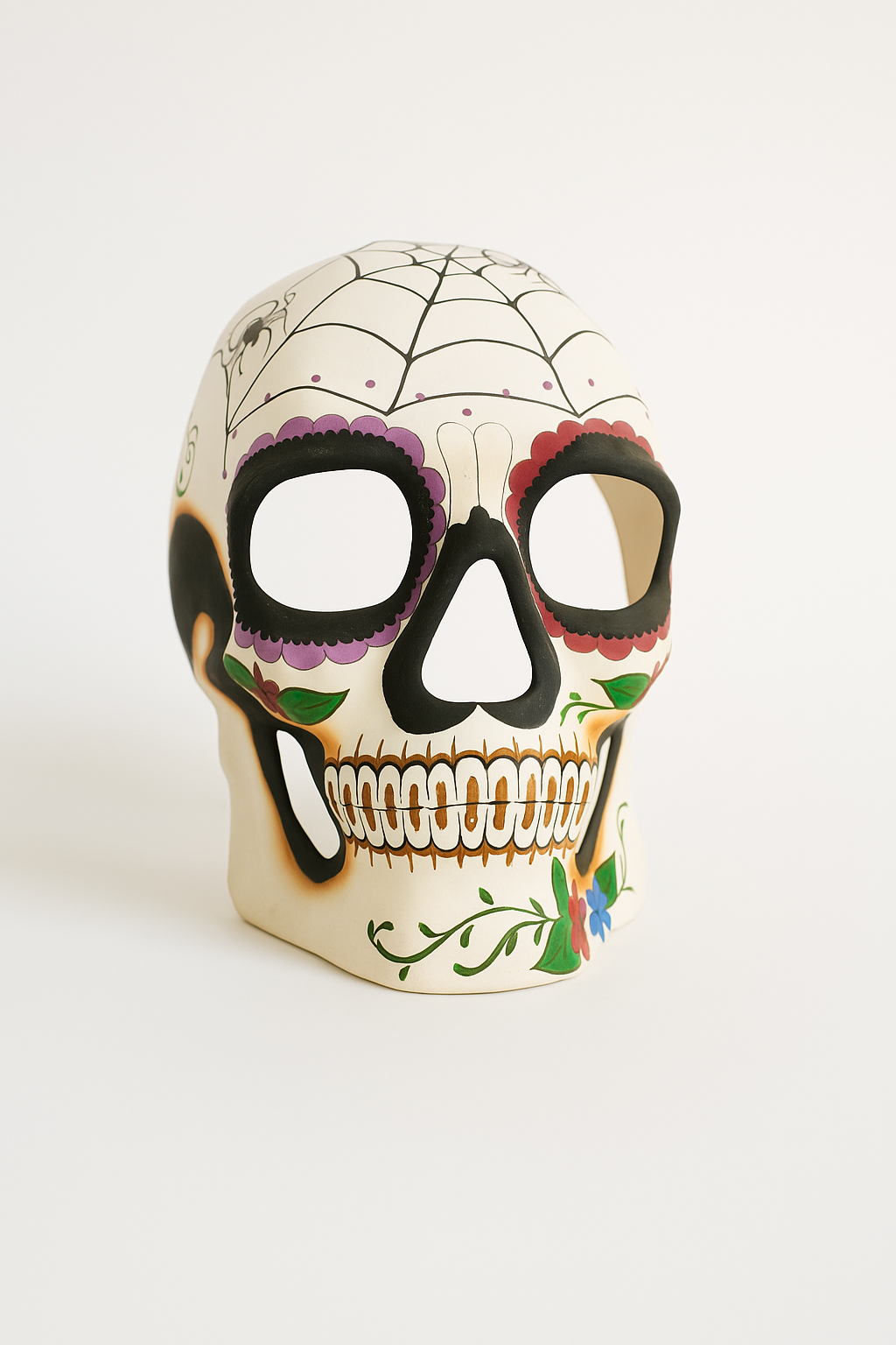 Día de los Muertos sugar skull mask with floral and teeth design.