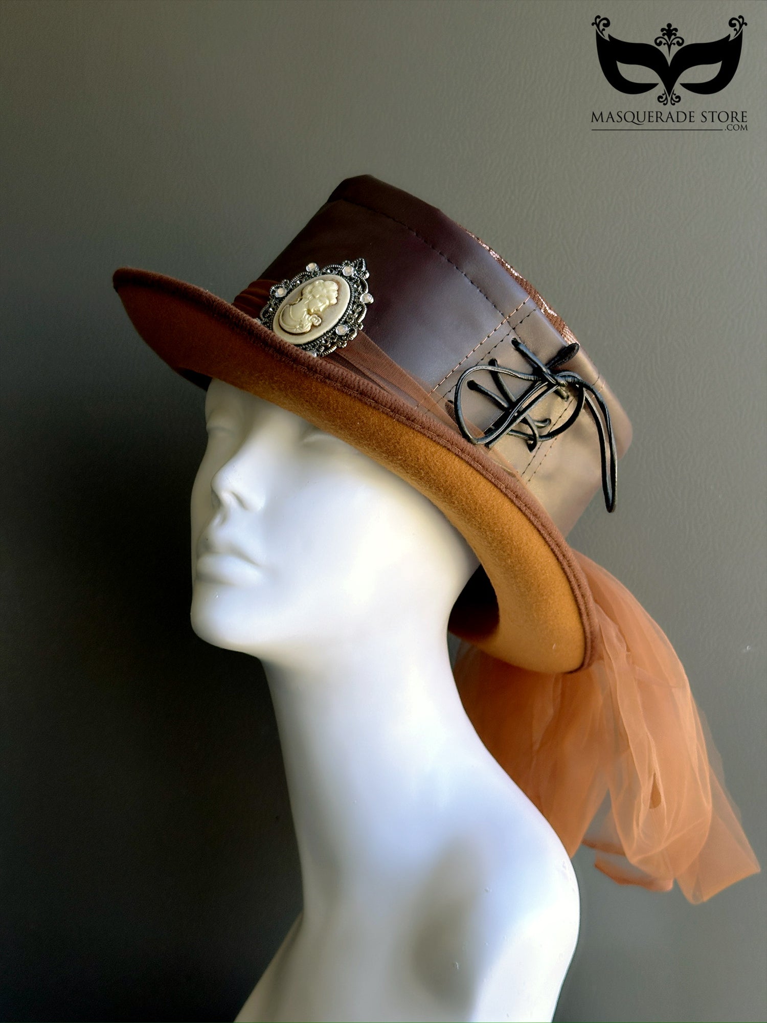 Steampunk top hat in brown vegan leather and fabric, with Victorian cameo brooch, black cord trim, and trailing tulle accent, ideal for costumes and cosplay.