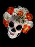Sugar skull mask with red, orange, and white floral accents, perfect for Dia de los Muertos celebrations

