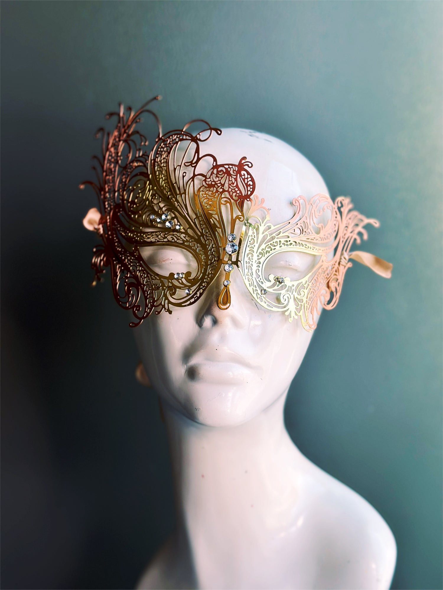 Gold and copper metal mask with swan silhouette, with rhinestones attached