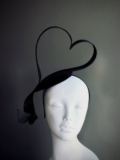 Black heart-shaped sculptural fascinator hat on headband