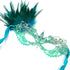Elegant turquoise masquerade mask with lace, feathers, and rhinestone details for costume balls and Mardi Gras.