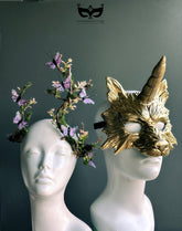 Moss butterfly crown and gold unicorn wolf mask displayed together as a woodland couples fantasy costume set