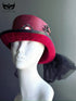 Red Victorian top hat with black velvet brim and cameo brooch for gothic masquerade or steampunk costume