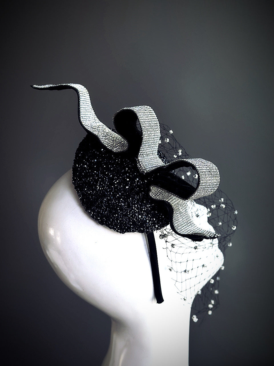Black rhinestone fascinator hat with dramatic crystal veil and vintage ribbon detail

