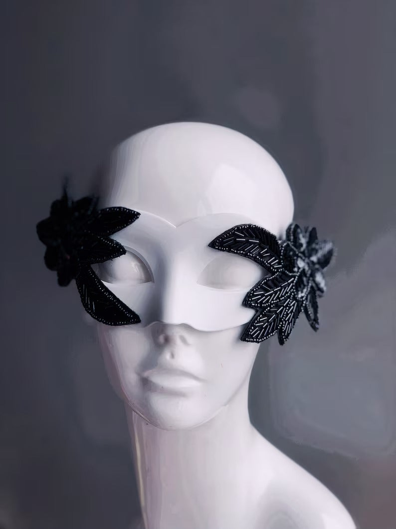 Nocturne Bloom white masquerade mask with black beaded floral accents, perfect for modern masquerade parties.
