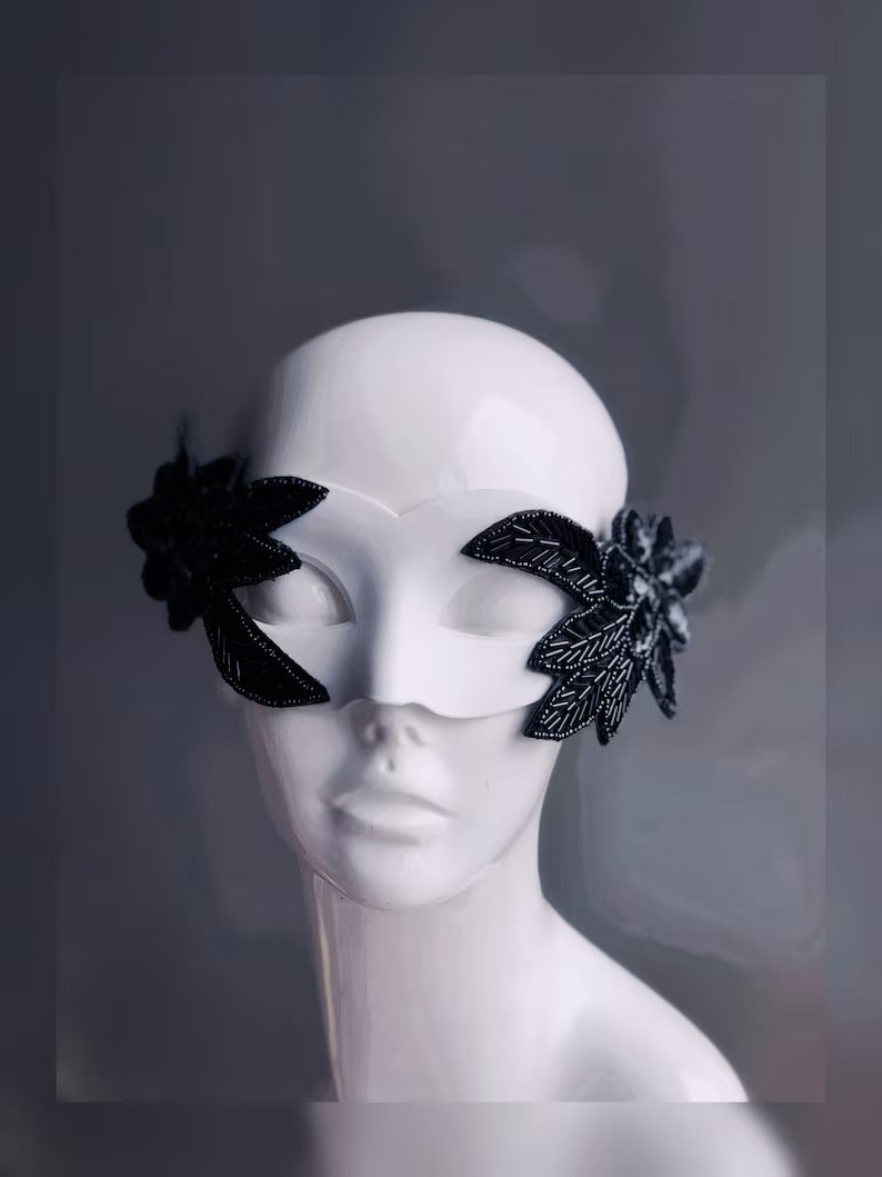 Nocturne Bloom white masquerade mask with black beaded floral accents, perfect for modern masquerade parties.