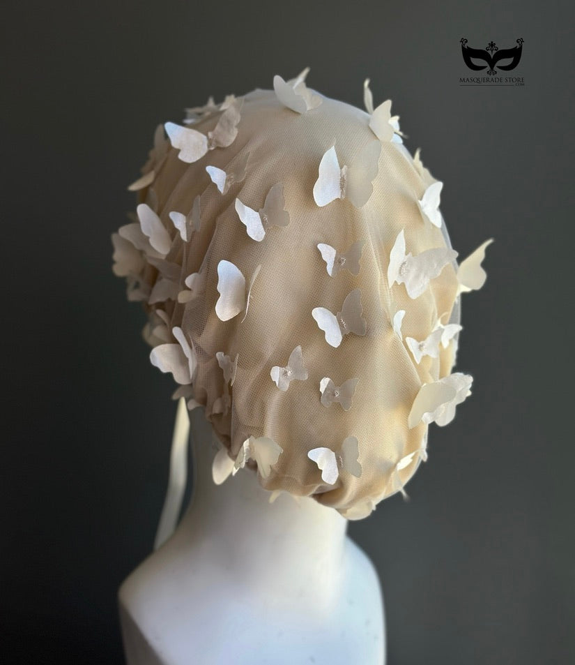 White butterfly face veil mask featuring dimensional butterfly appliqués attached to a sheer mesh hood, creating an ethereal bridal couture-inspired fashion accessory for wedding editorials, runway shows, cosplay, fantasy photoshoots, and artistic performances.