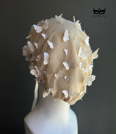 White butterfly face veil mask featuring dimensional butterfly appliqués attached to a sheer mesh hood, creating an ethereal bridal couture-inspired fashion accessory for wedding editorials, runway shows, cosplay, fantasy photoshoots, and artistic performances.