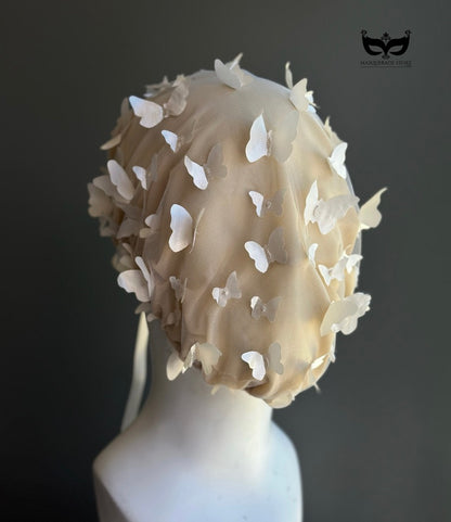 White butterfly face veil mask featuring dimensional butterfly appliqués attached to a sheer mesh hood, creating an ethereal bridal couture-inspired fashion accessory for wedding editorials, runway shows, cosplay, fantasy photoshoots, and artistic performances.