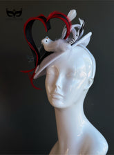 White fascinator hat with heart shape and two decorative birds