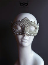 White pearl beaded masquerade mask with rhinestone details and elegant shaping.
