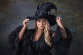 Customer wearing a witch hat adorned with butterflies - masquerade costume accessory