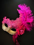 Hot pink and gold mask with feathers and gems.
