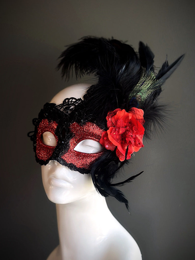 Black and red feather masquerade mask with lace, gems, and glitter.