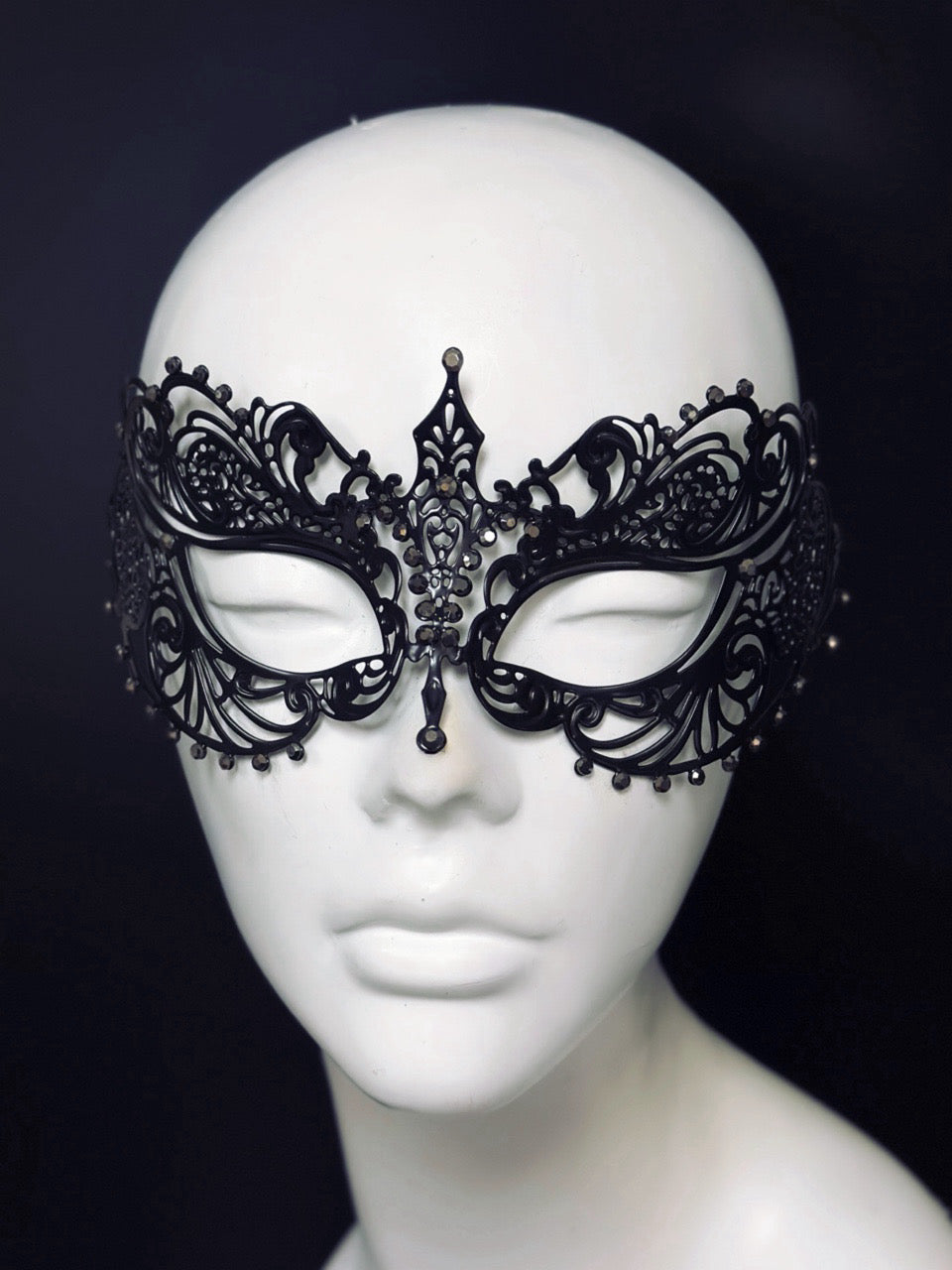 Black filigree laser cut metal masquerade mask with gun metal colored rhinestones.