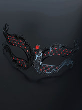 Black metal masquerade mask with ruby red rhinestones.