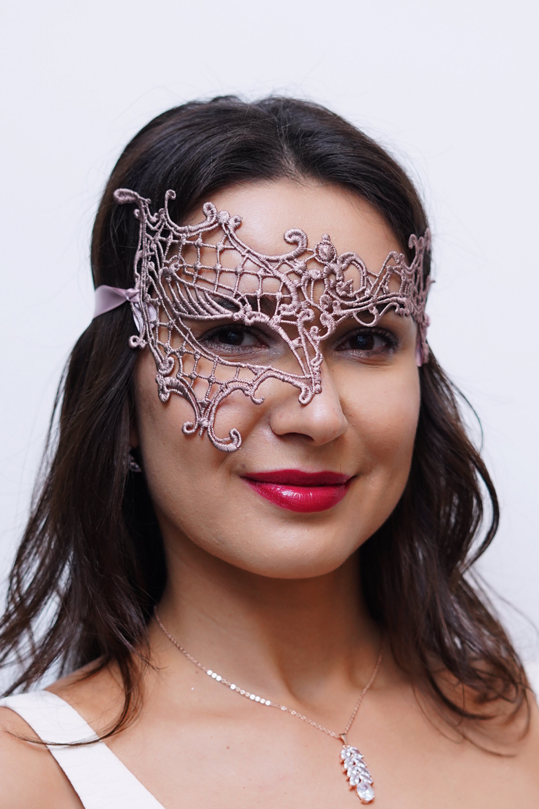 Rose gold half face phantom lace masquerade mask with matching rose gold ribbons.