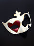 Red heart and black club card symbols over the eyes of a masquerade mask, with gold details.