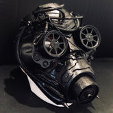 Cyberpunk-style black mask with rotating wheels and rugged steampunk elements