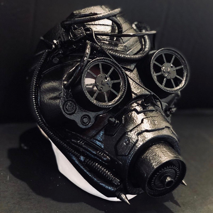 Cyberpunk-style black mask with rotating wheels and rugged steampunk elements