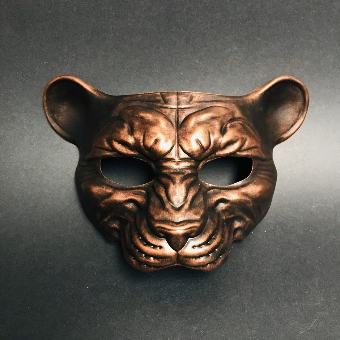 Metallic copper animal face mask with panther shape for jungle or fantasy masquerade events