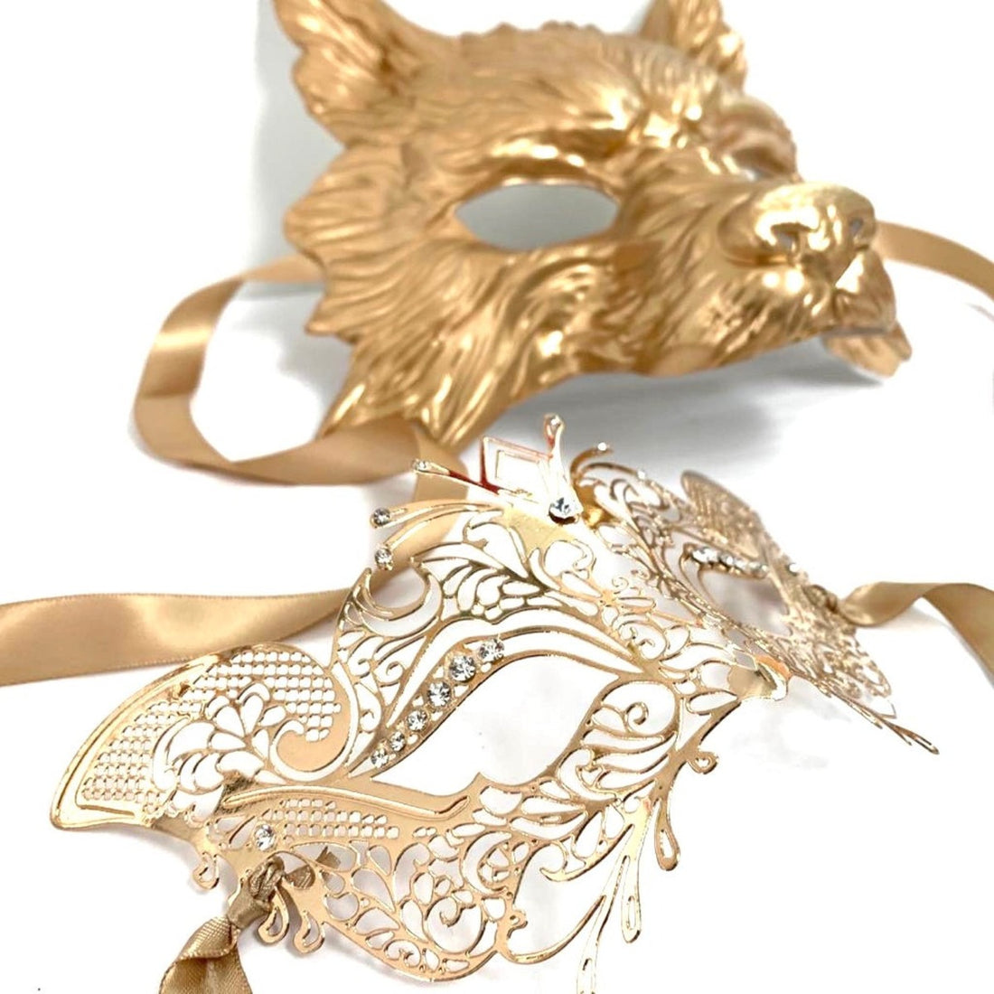 Elegant gold masquerade mask pair featuring a sculpted wolf and delicate lace metal mask
