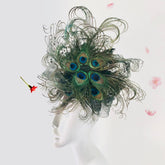 Statement green fascinator hat with dramatic peacock feathers, ideal for race day or themed events