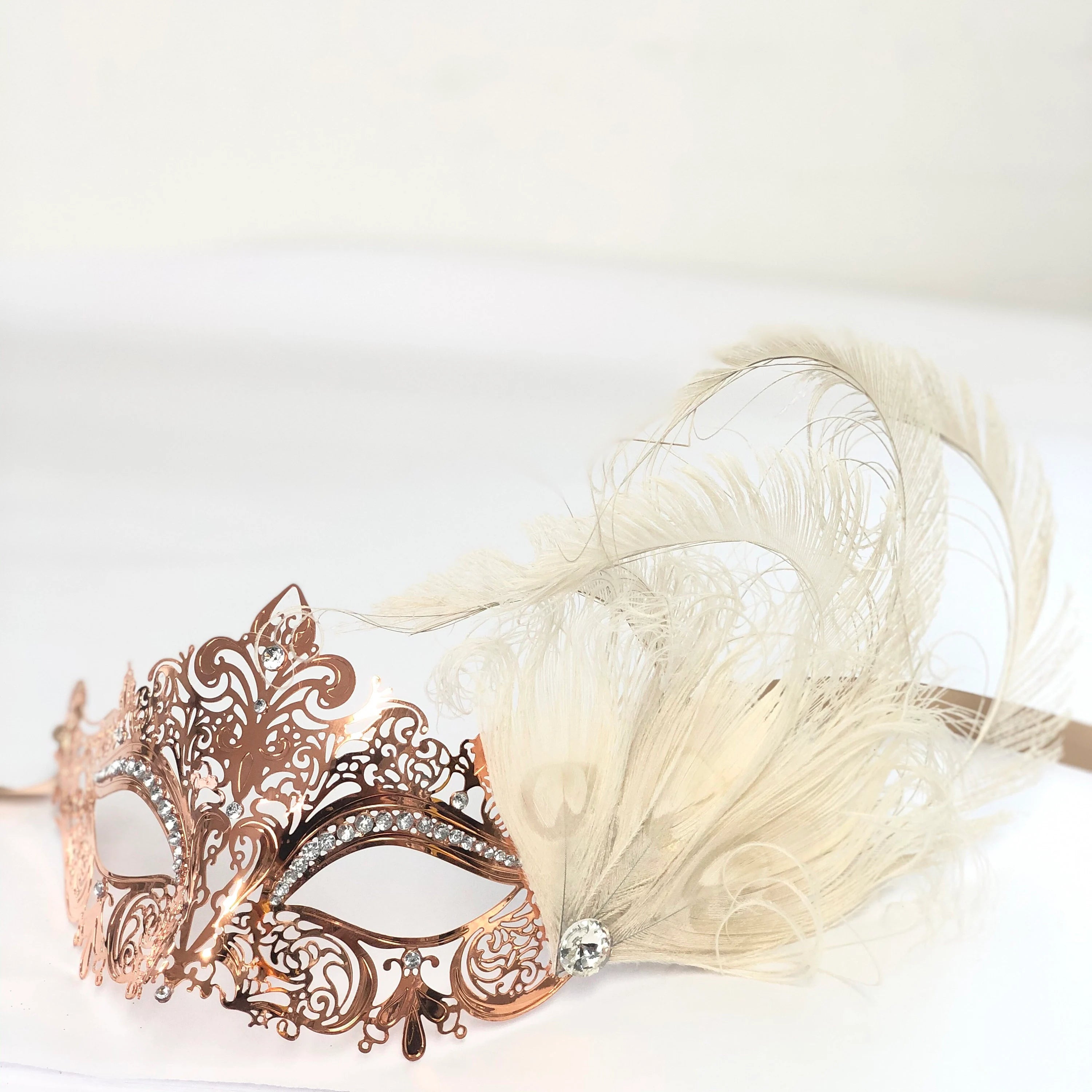 rose gold metal mask with ivory feathers
